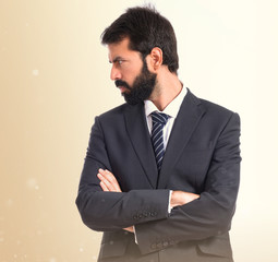Businessman with his arms crossed over white background
