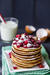 Pancake with cranberries, raspberries, honey and powdered sugar