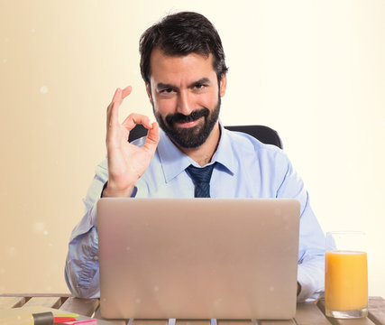 Businessman in his office making Ok sign