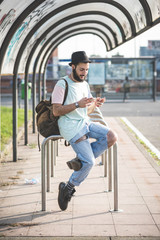 young handsome hipster gay modern man using smartphone