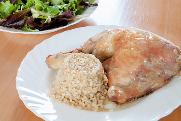 Roasted chicken with rice and salad.