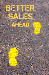 Yellow footsteps on sidewalk towards Better Sales Ahead message