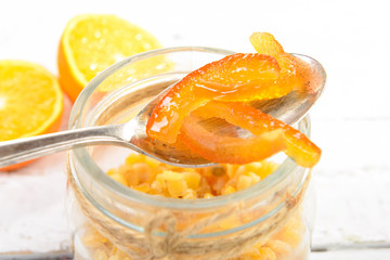 candied oranges cut into pieces on the white wooden table
