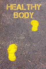 Yellow footsteps on sidewalk towards Healthy Body message