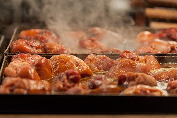 Meat is fried on a big frying pan at street fair