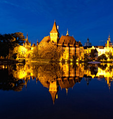Fototapeta na wymiar Vajdahunyad Castle is reflected in water, Budapest