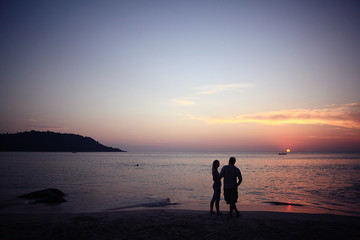 sunset on the beach silhouettes of people