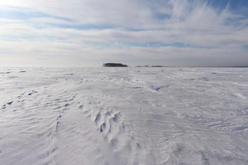 Fototapeta na wymiar Way to the island on the frozen river