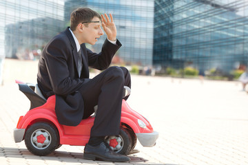 Businessman and Toy Red Car