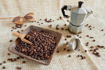 coffee roasted beans  next to an Italian moka