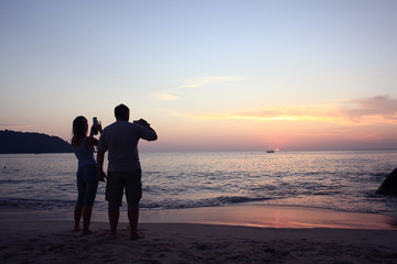 sunset on the beach silhouettes of people