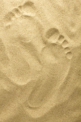 Fototapeta na wymiar Two footprints in sand at the beach