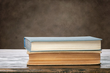 Books on brown grungy background