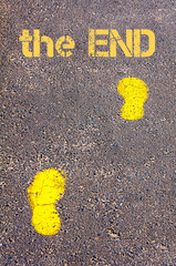 Yellow footsteps on sidewalk towards The End message