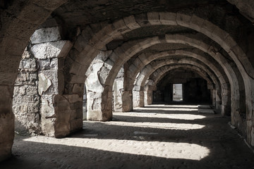 Interior of empty dark corridor with arcs