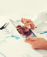 woman with tablet pc and chart papers