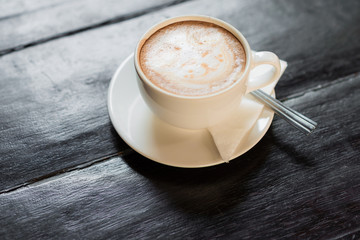 Cup of coffee on wooden table
