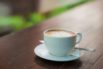 Coffee cup on wood table in coffee shop