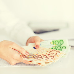 woman hands with euro cash money