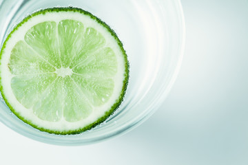 slices of lime in a glass of mineral water