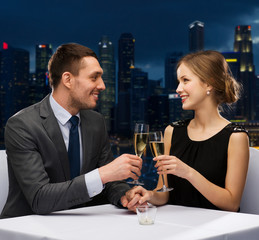 couple with glasses of champagne at restaurant