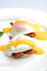 Eggs Benedict- toasted English muffins, ham, poached eggs