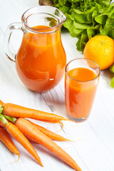 carrot juice on white wood table