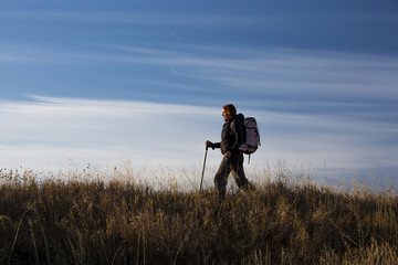 Female hiker walks along the ridge