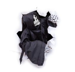 Grim reaper looking through hole torn in white paper