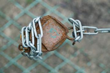 pole iron chain link fence on a street car parking City