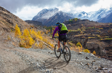 Fototapeta premium Biker-girl in Himalaya mountains, Anapurna region