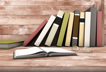 The open book and glasses against the wooden shelf with books