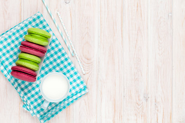 Colorful macarons and cup of milk