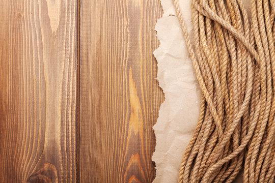 Wooden background with marine rope