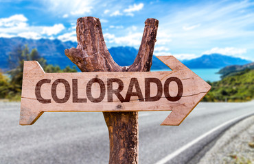Colorado wooden sign with a road background