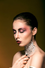 portrait girl with beautiful makeup and silver on the neck