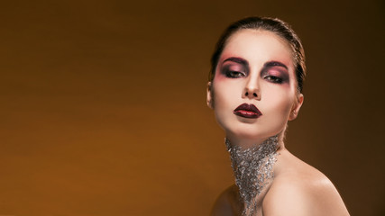 portrait girl with beautiful makeup and silver on the neck
