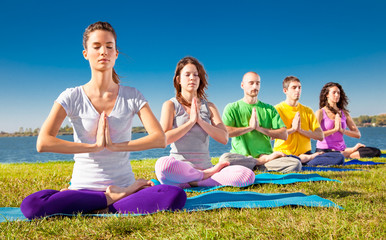 Group of young people have meditation on yoga class.