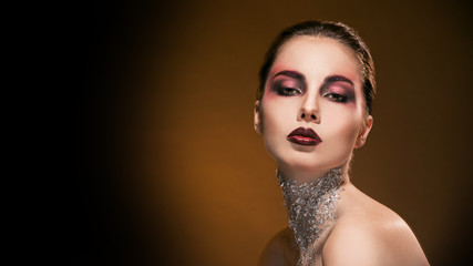 portrait girl with beautiful makeup and silver on the neck