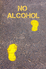 Yellow footsteps on sidewalk towards No Alcohol message