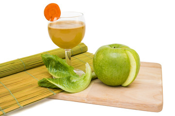 Apple juice and apple on a cutting board