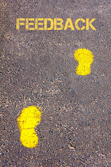 Yellow footsteps on sidewalk towards Feedback message