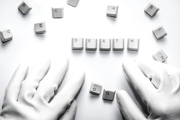 Hands with gloves typesetting death with white keys on white