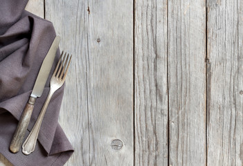 Vintage fork and knife on wood