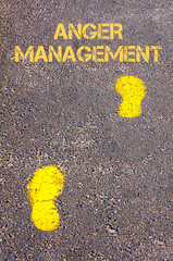 Yellow footsteps on sidewalk towards Anger Management message