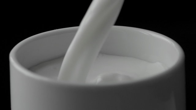 Milk poured into the mug in slow motion