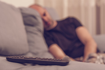 Young man sleeping in the sofa, watching tv - 79181396