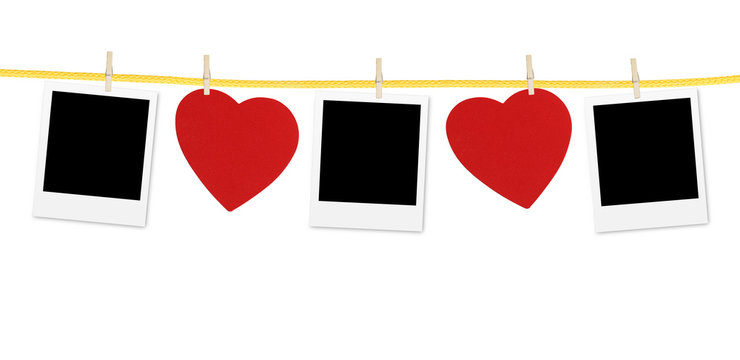 Vintage photos frame on the clothesline with hearts over white
