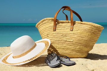 white hat and wicker bag