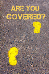 Yellow footsteps on sidewalk towards Are you Covered message